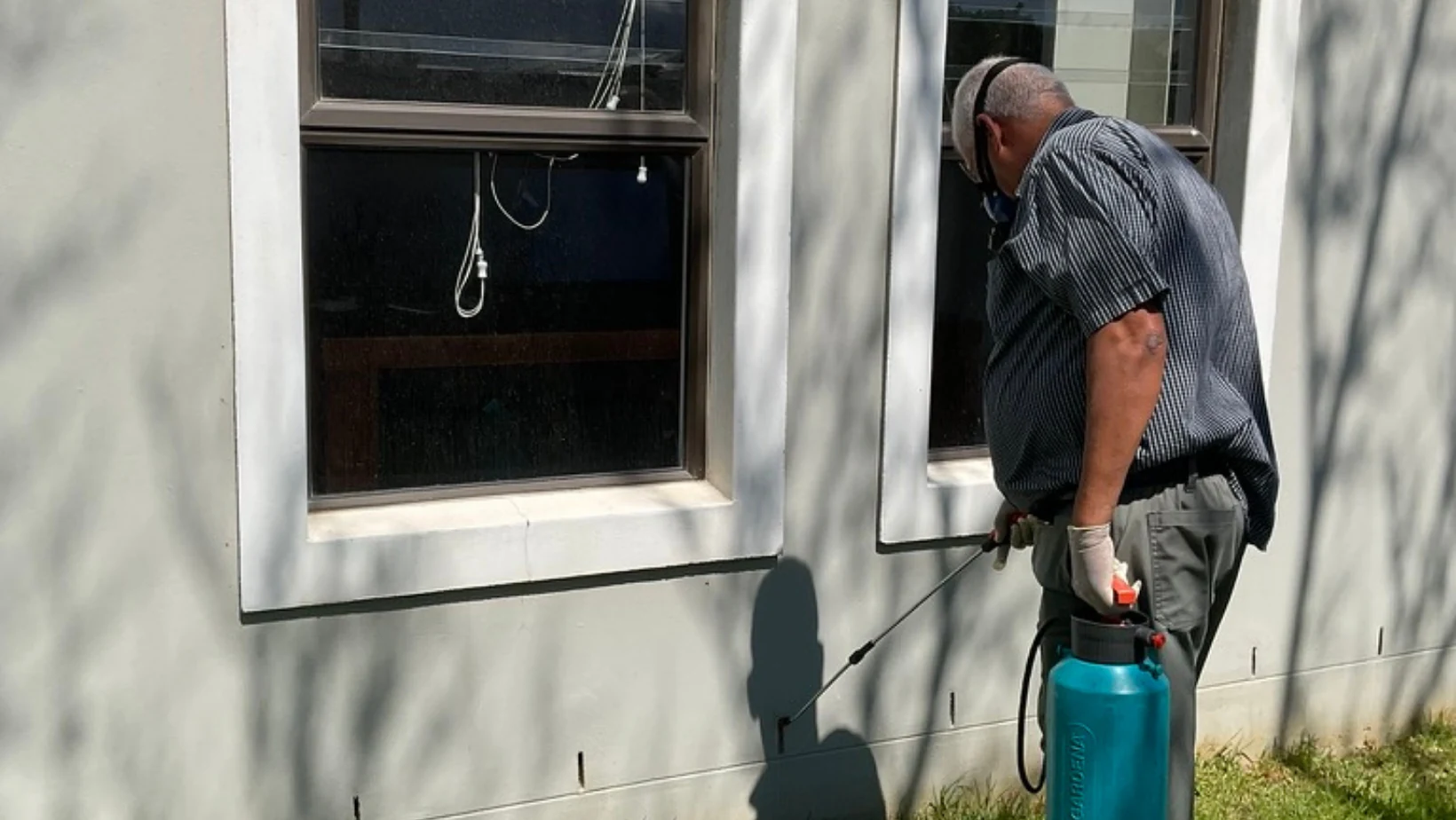 Technician cleaning an exterior window