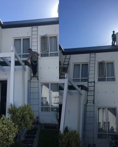 High-reach pest control using safety harness in Stellenbosch by Boland Cleaning team.