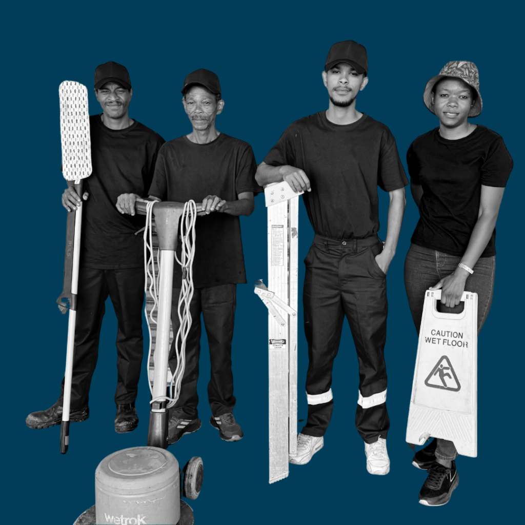 Four cleaning staff with tools, ladder and wet floor sign on a blue background