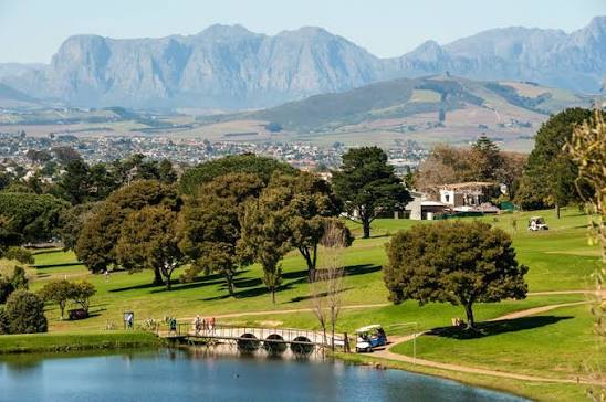 Cape Town Northern Suburbs landscape with golf course, trees and mountains in the background